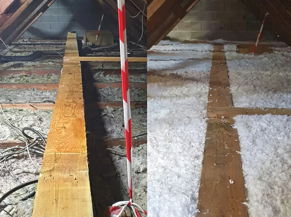 Ouvrier en équipement de protection individuelle installant de l'isolation thermique dans les combles d'une habitation